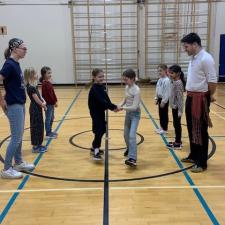 Metis Jigger demonstrating to an elementary class in the gym