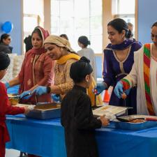 Students in line, receiving their food from the PAC